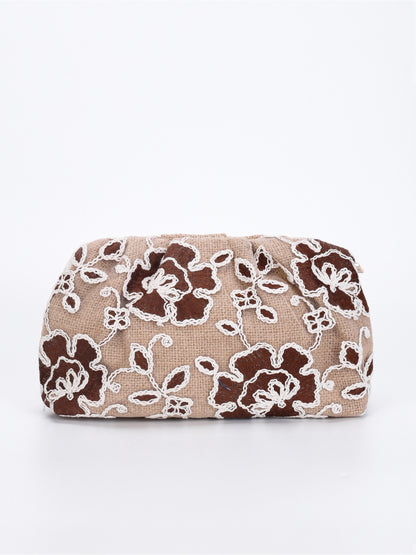 Cosbai clutch bag held in hand to show scale and intricate floral sequin design