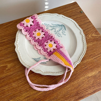 Model outdoors wearing crochet flower hairband with sunlight highlighting flowers