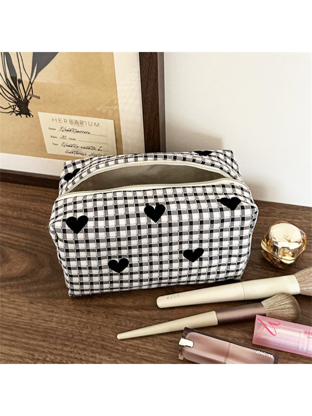 Side view of black and white heart makeup bag highlighting and shape