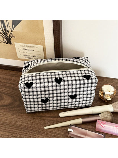 Side view of black and white heart makeup bag highlighting and shape