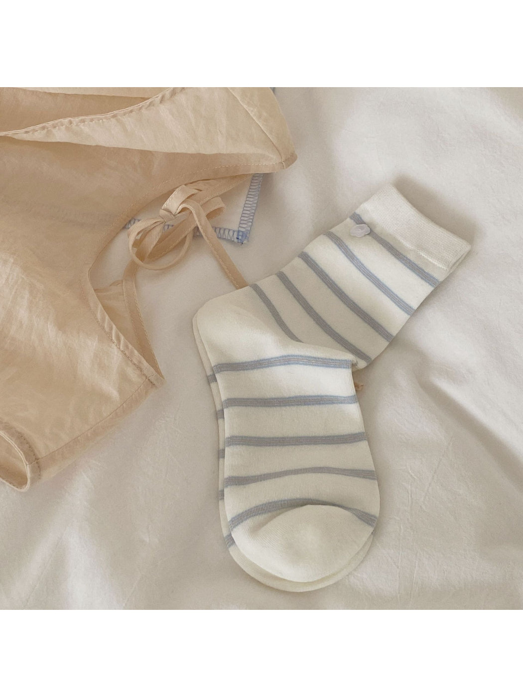 Side view of Rufia pastel pink crew socks highlighting ruffle cuff