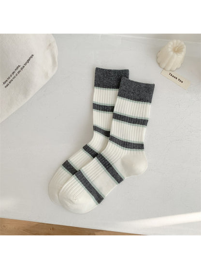Flat lay of Rufia everyday crew socks with playful stripes arranged in a fan shape