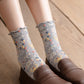 Rufia Heart White Mid-Calf Socks worn with casual shoes showing heart pattern on sides