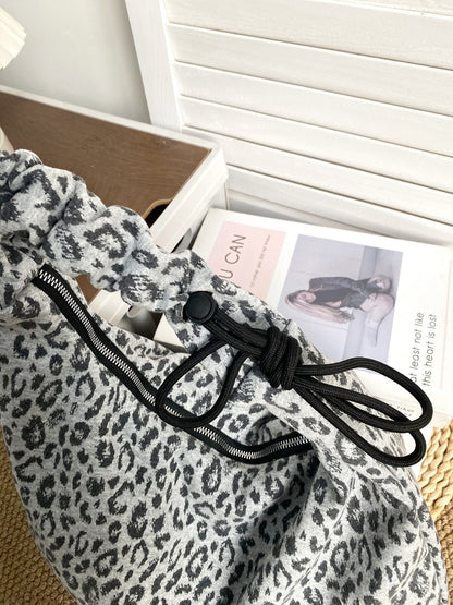 Back view of Cosbai leopard slouchy shoulder bag showing smooth fabric and strap attachment