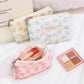 Cosbai floral coin purse held in hand displaying size and floral print