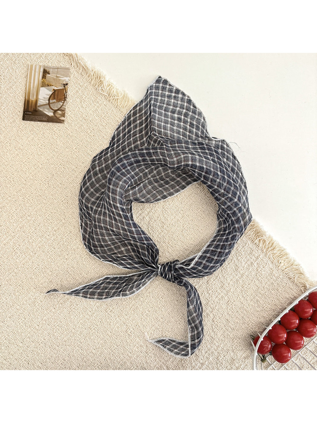 Model adjusting Scarvii triangle scarf around neck highlighting versatility and style