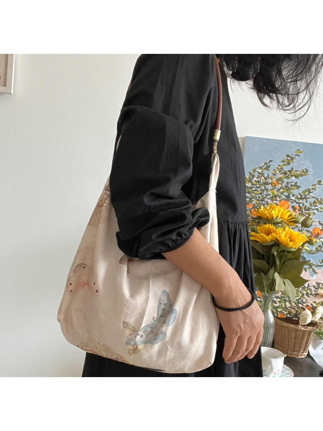 Cosbai butterfly print tote bag displayed hanging on a hook
