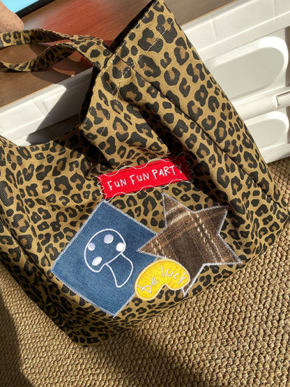 Cosbai street style leopard carry bag resting on wooden bench with light