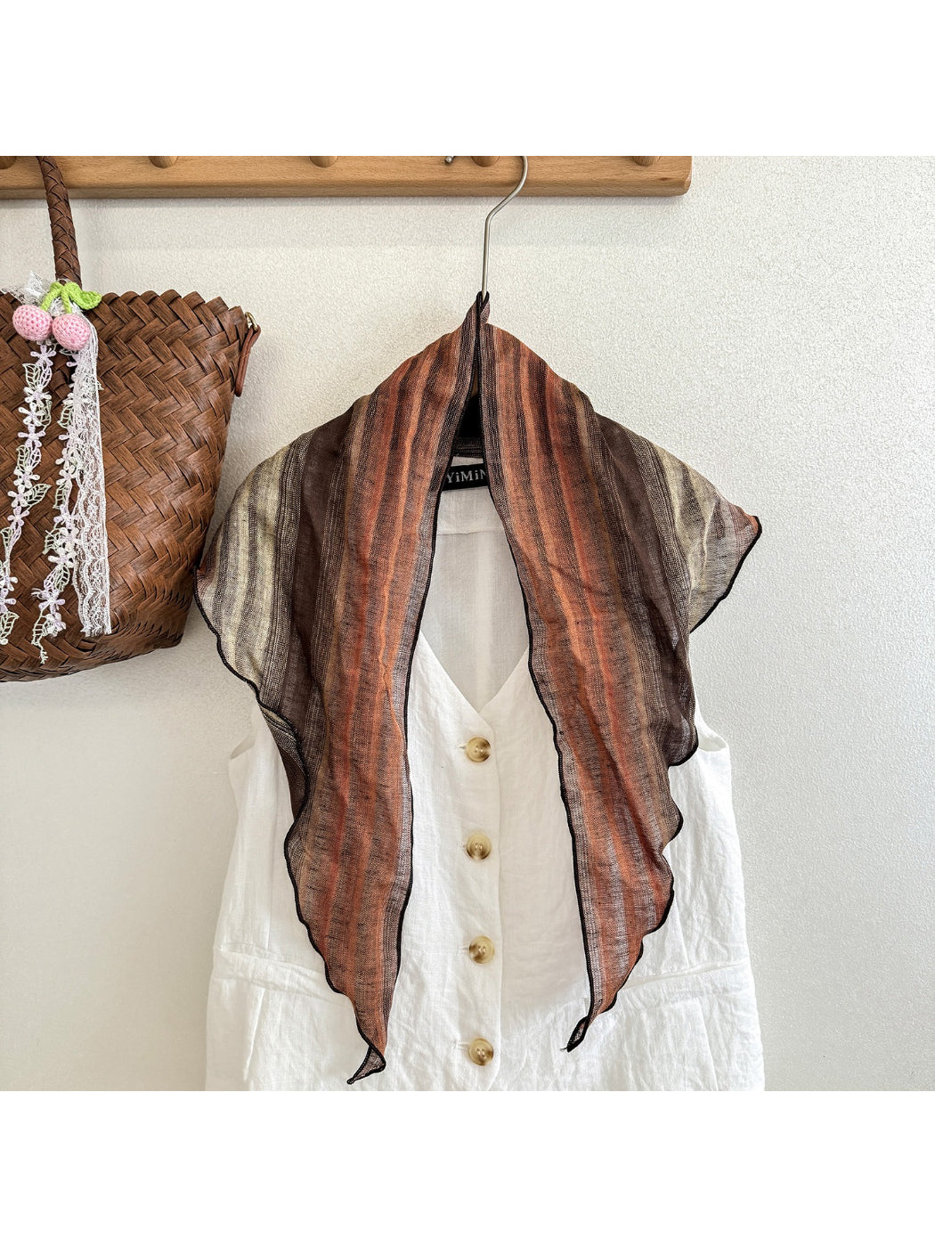 Model wearing sheer gradient triangle scarf styled around the neck with casual outfit
