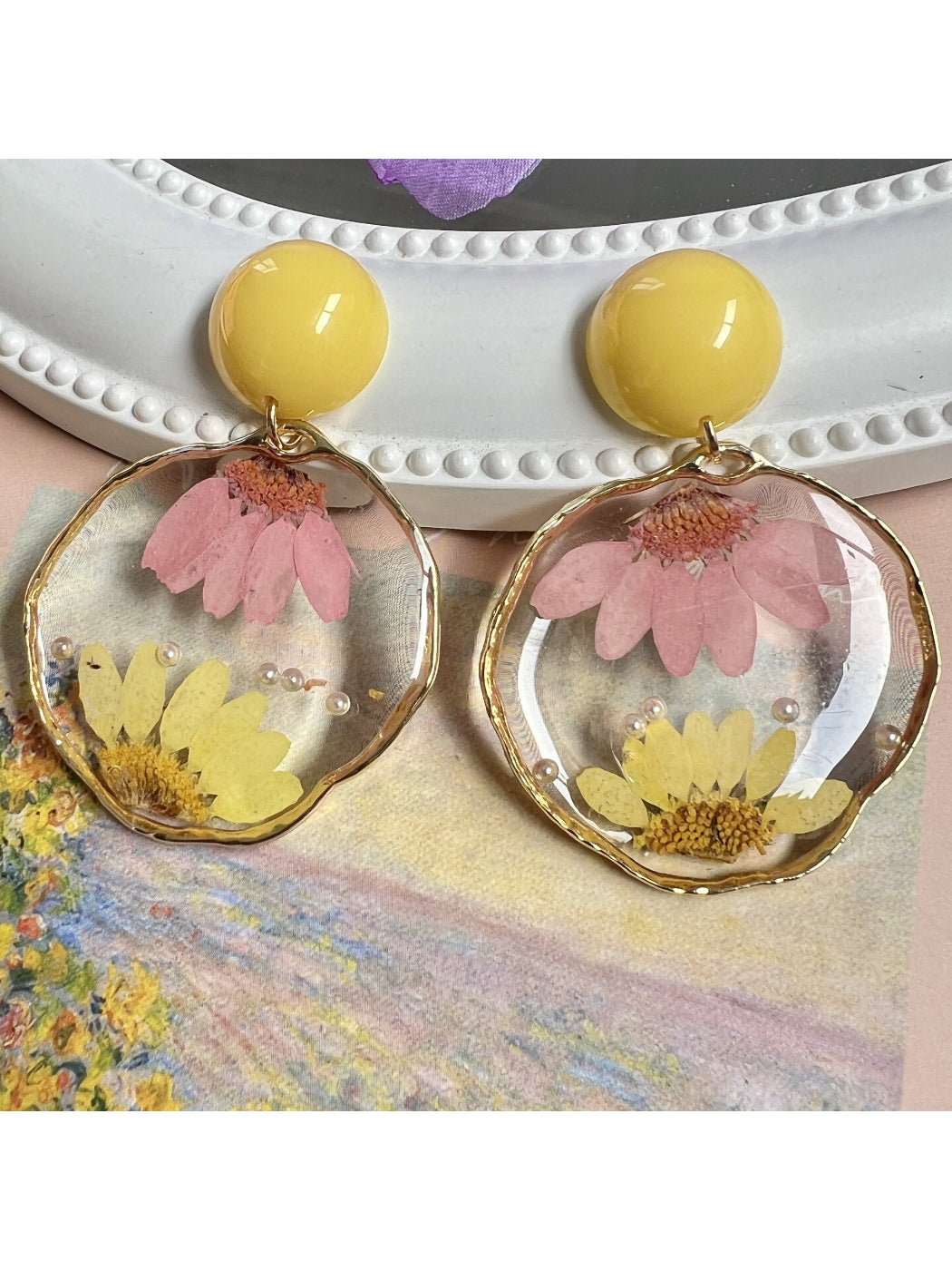 Clear floral statement earrings with intricate flower design and gold accents