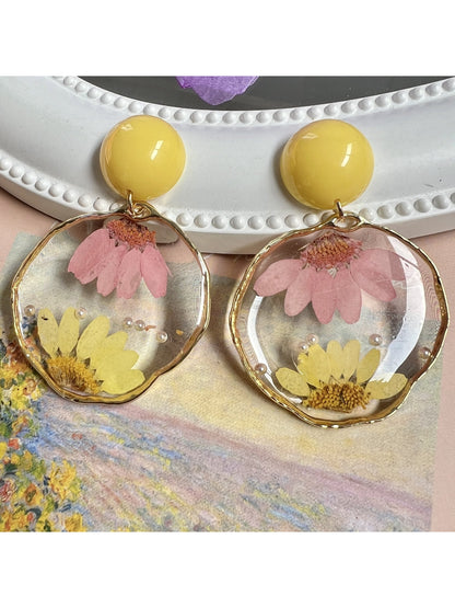 Clear floral statement earrings with intricate flower design and gold accents