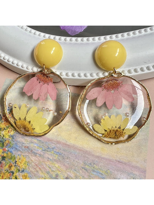 Clear floral statement earrings with intricate flower design and gold accents
