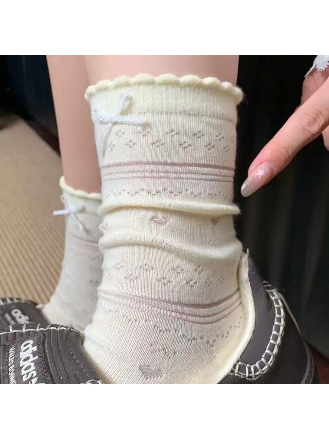 Close-up of soft blue socks showing delicate ribbon detail