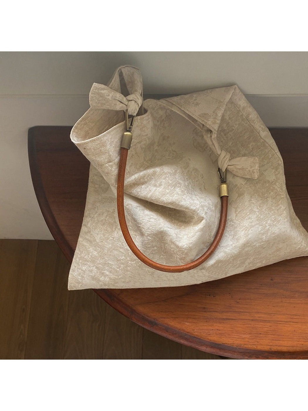 Ivory hobo bag with intricate pattern and soft texture