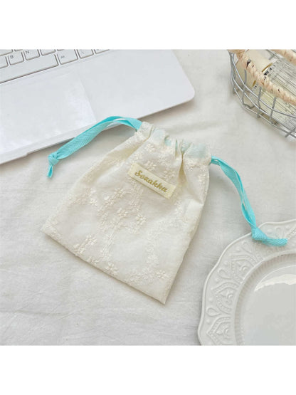 Cosbai floral lace drawstring pouch held in hand highlighting size and lace design