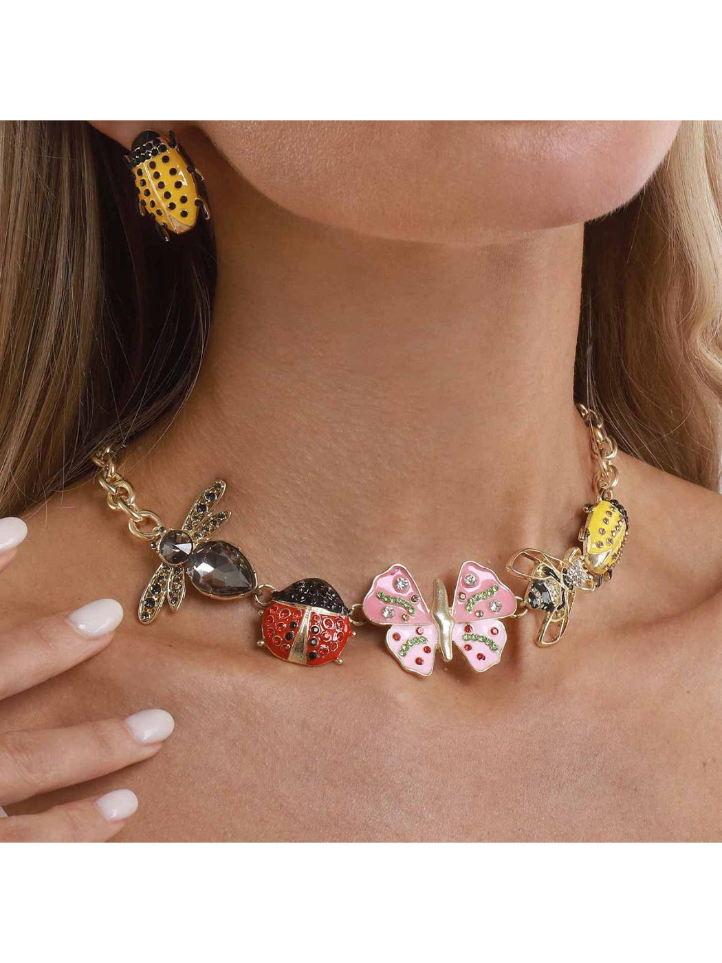 Close-up of Neckit Butterfly & Bug Charm Necklace with silver chain and detailed charms