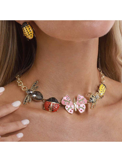 Close-up of Neckit Butterfly & Bug Charm Necklace with silver chain and detailed charms