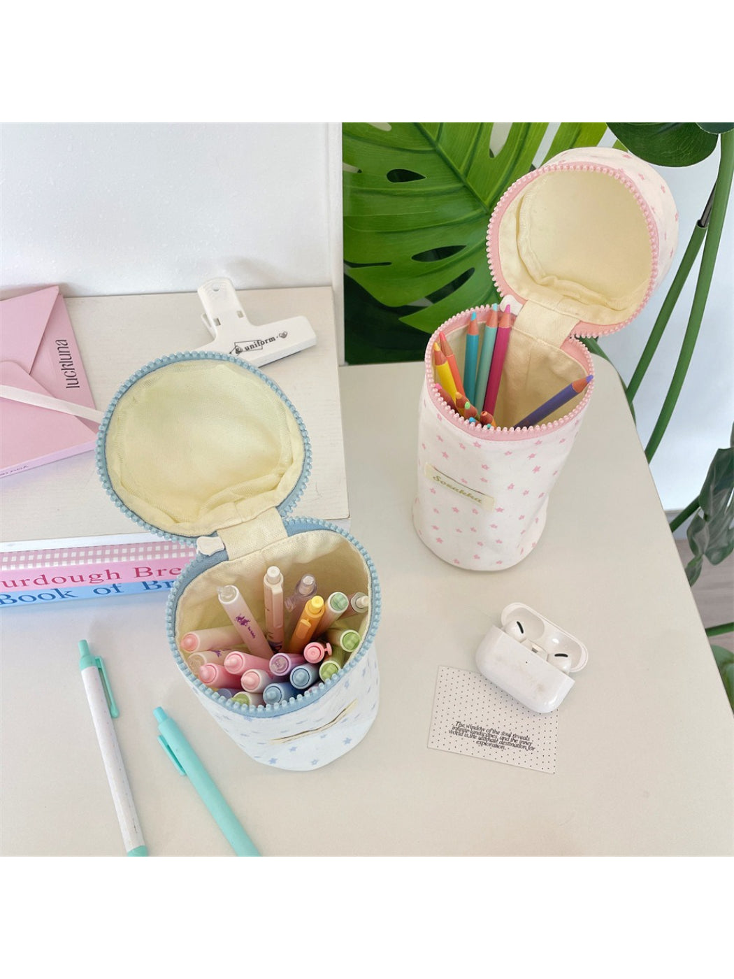 Cosbai star print cylinder pencil pouch displayed next to school supplies