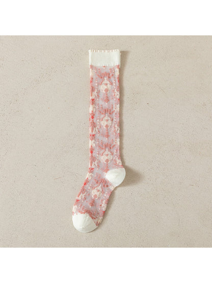 Rufia sheer socks in soft pink and lavender colors folded neatly