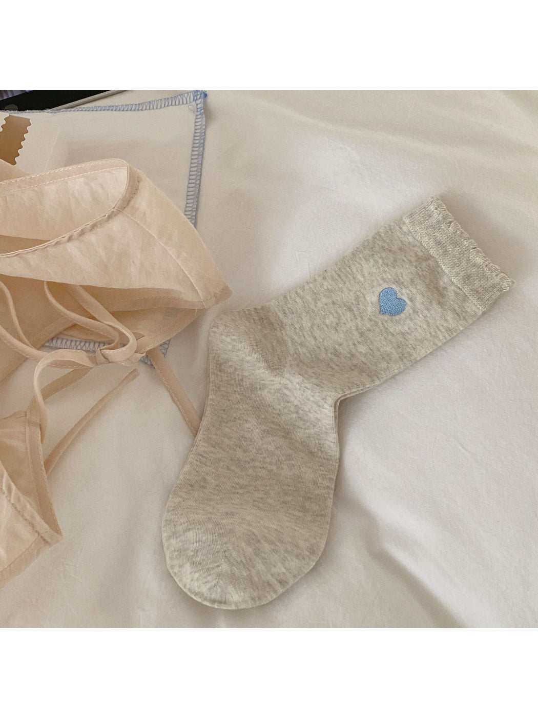 Close-up of soft knit fabric and ruffle trim on Rufia crew socks