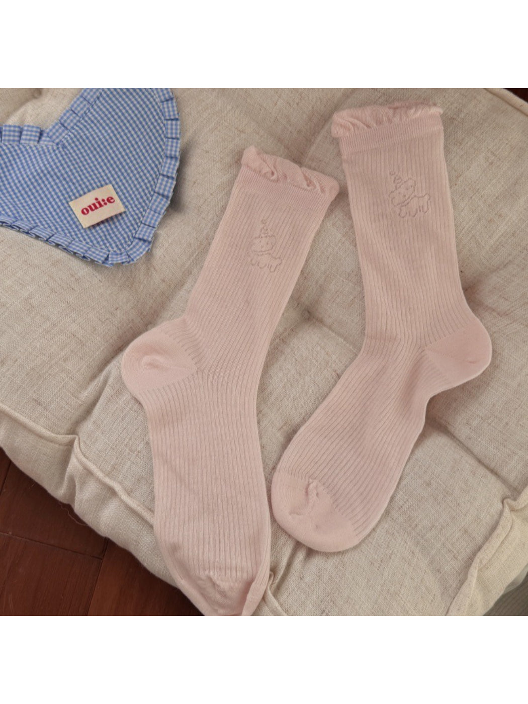 Multiple pairs of Rufia minimal animal crew socks in different colors arranged neatly