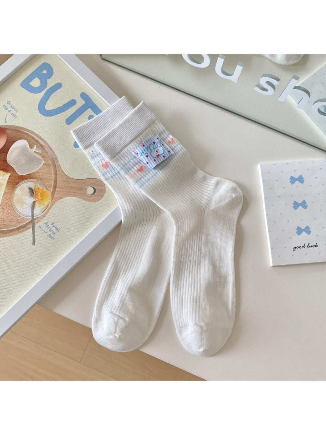 Rufia Sweet Blue Ribbon crew socks folded neatly with blue ribbon design