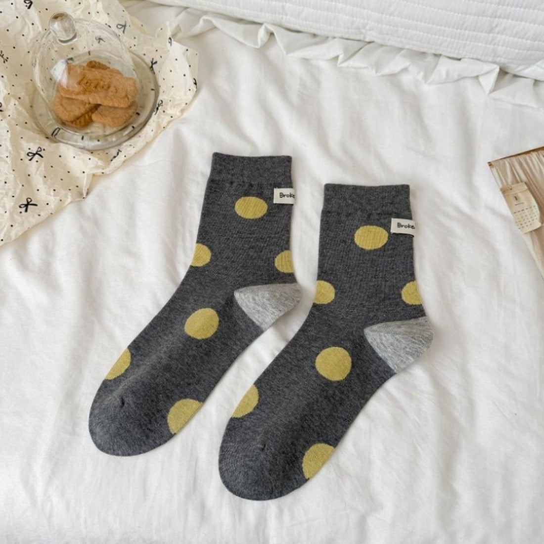 Rufia socks laid flat highlighting the contrast heel and dot pattern design