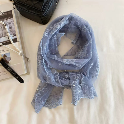 Flat lay of sheer botanical mesh scarf showing delicate leaf details