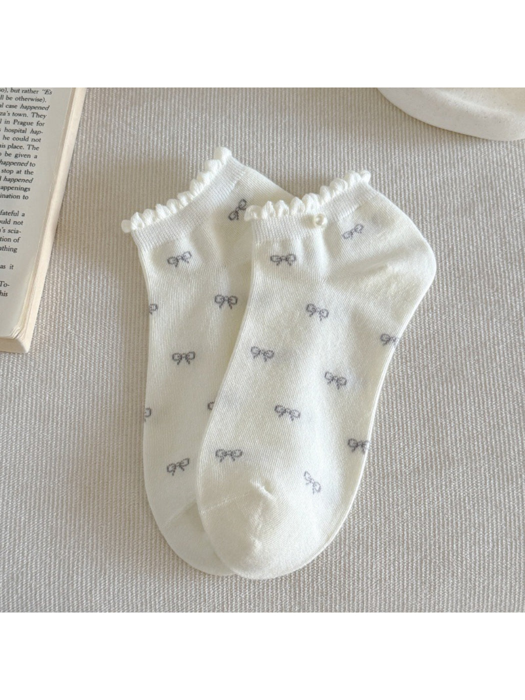 Side view of Rufia ankle socks highlighting frill trim and bow design