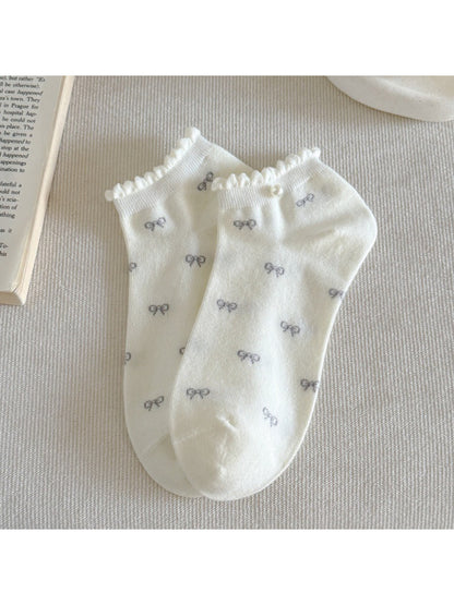 Side view of Rufia ankle socks highlighting frill trim and bow design