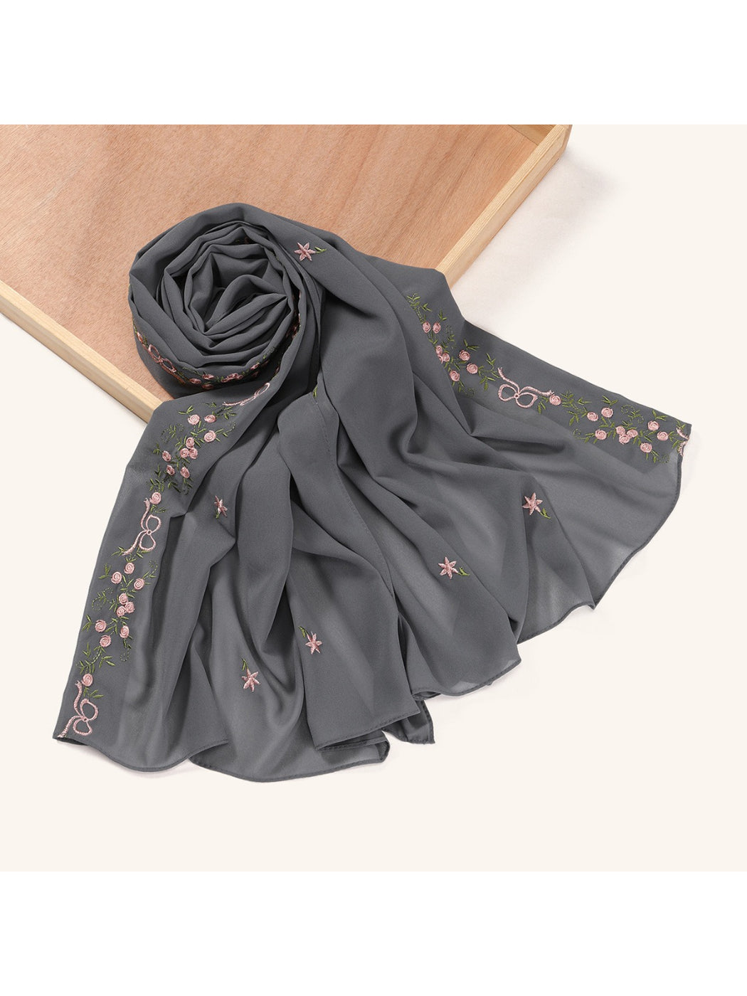 Side view of scarf showing texture and embroidered floral design