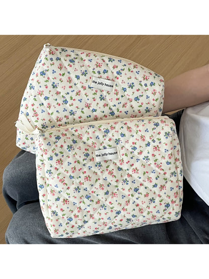 Open view of Cosbai Vintage Blossom Travel Organizer showing organized travel essentials