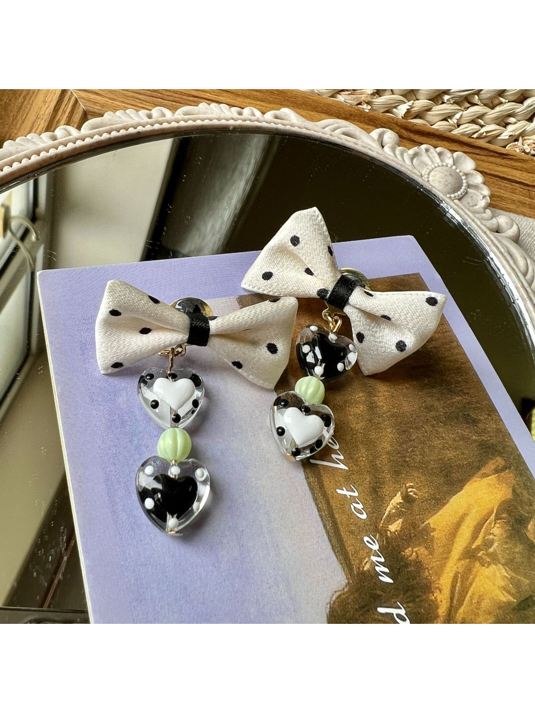 Earwish Heart Charm Bow Earrings worn on ear showcasing size and fit