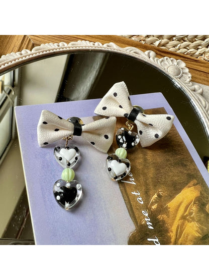 Earwish Heart Charm Bow Earrings worn on ear showcasing size and fit