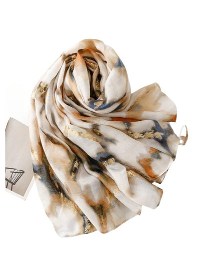 Folded marble print scarf highlighting its lightweight and soft fabric