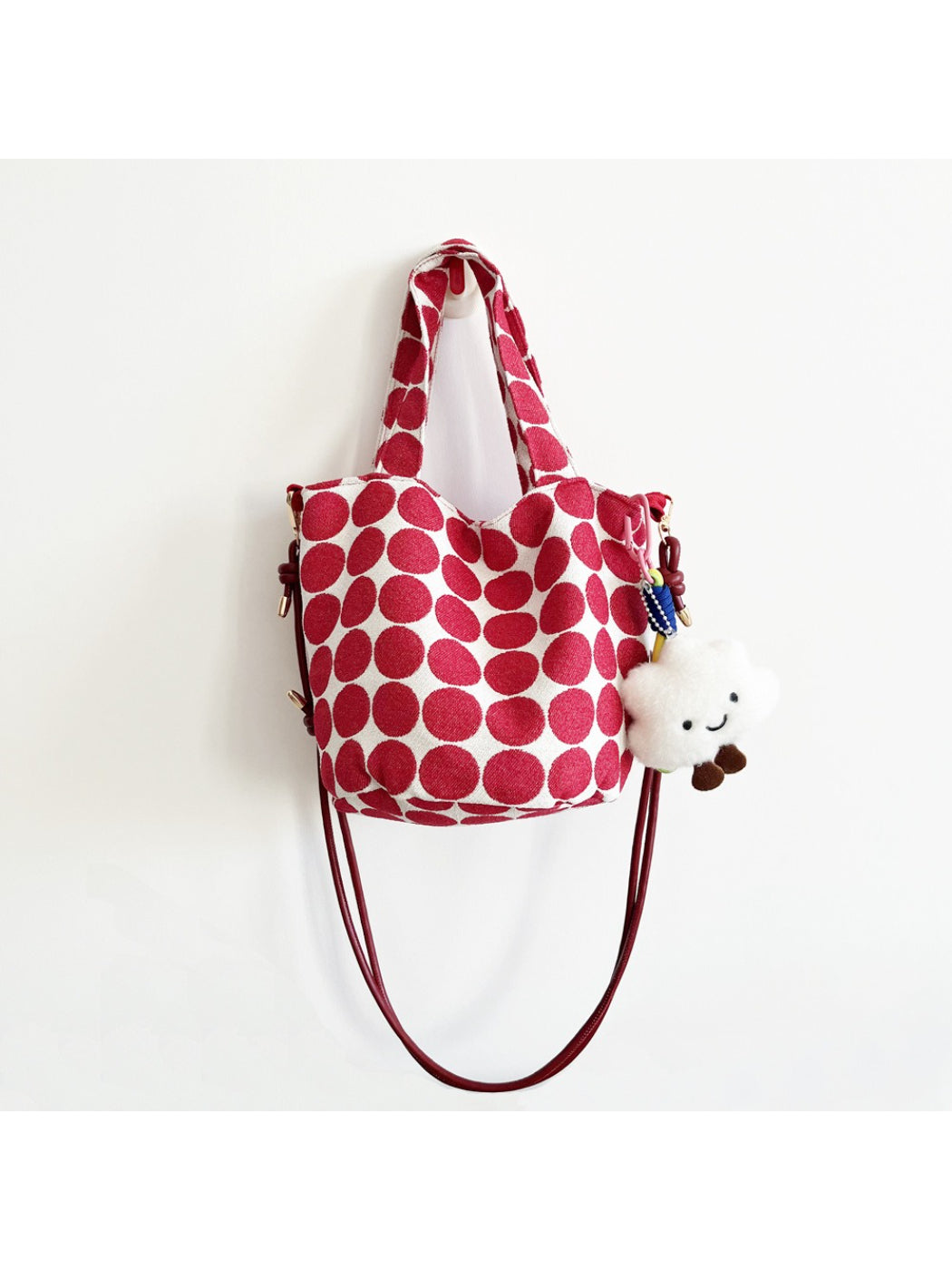 Cosbai Polka Dot Mini Tote Bag with handles held in hand for size reference