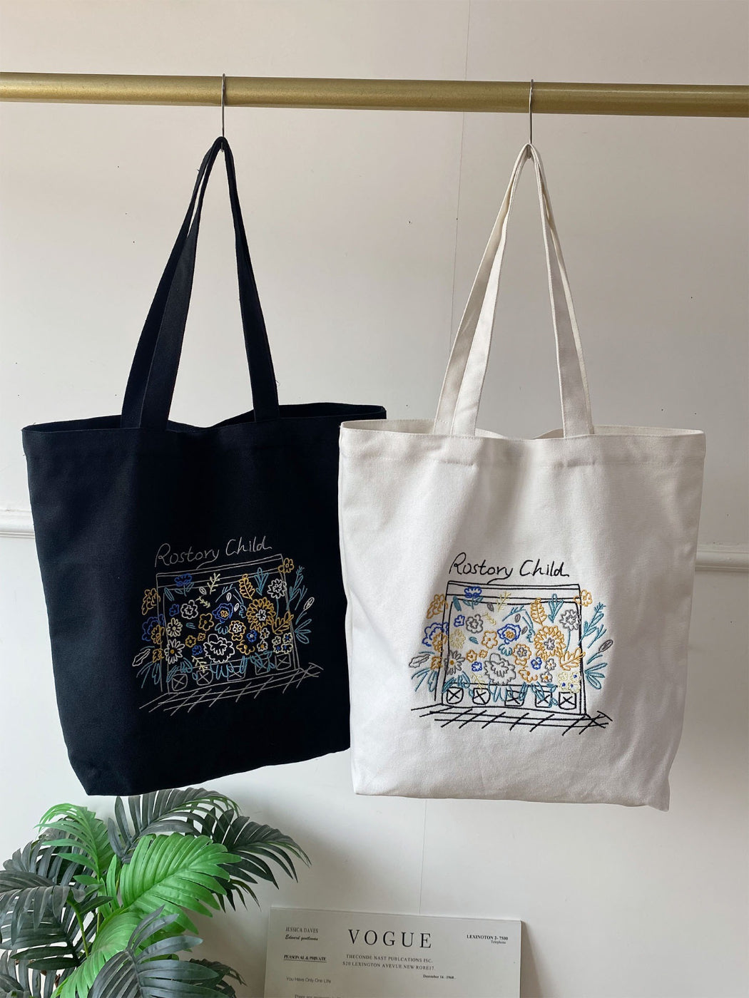 Flat lay of Cosbai floral illustration tote bag on wooden surface