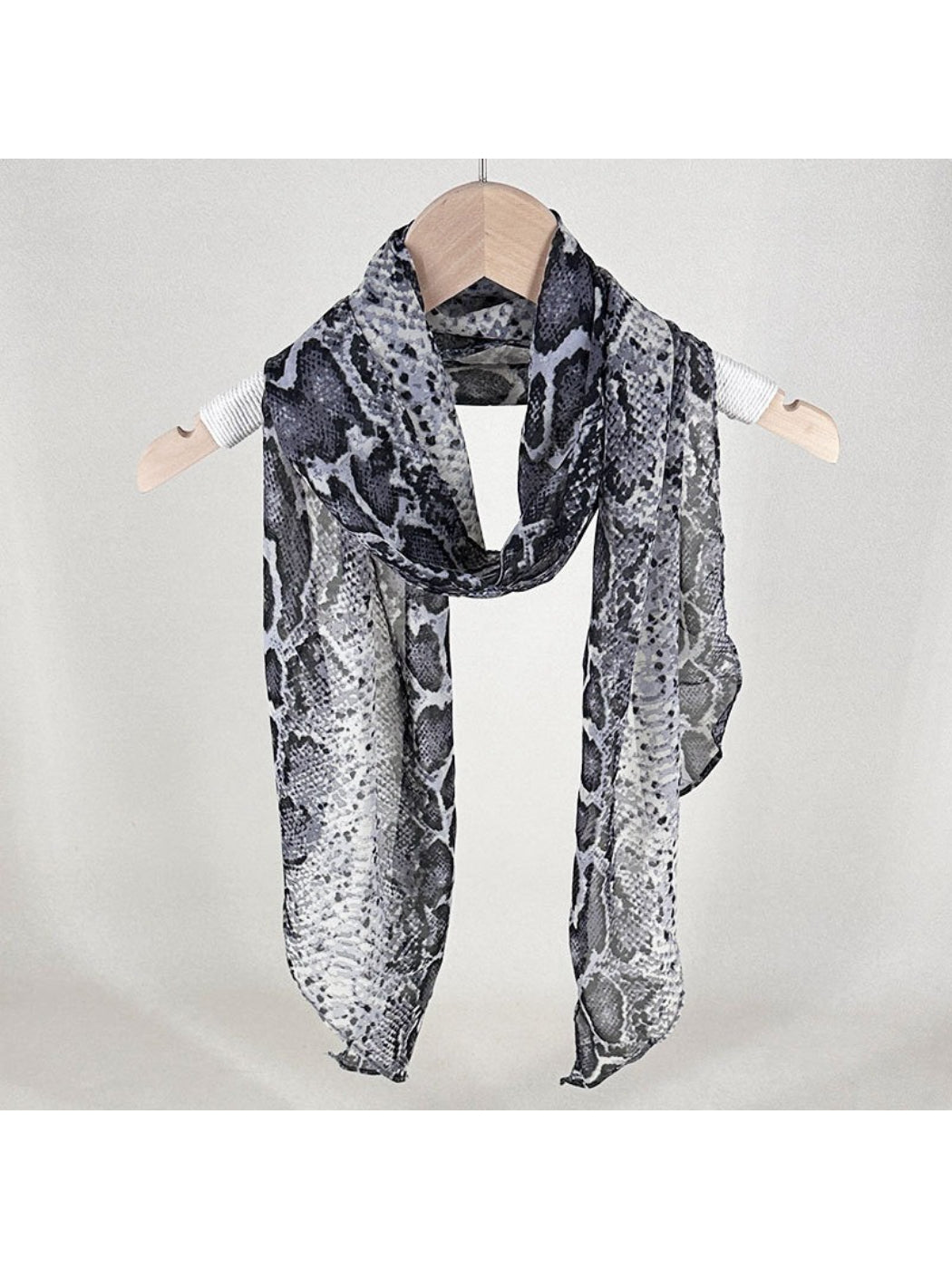 Scarf draped over a chair showing full snake print design