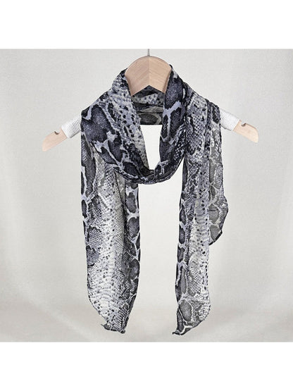 Scarf draped over a chair showing full snake print design