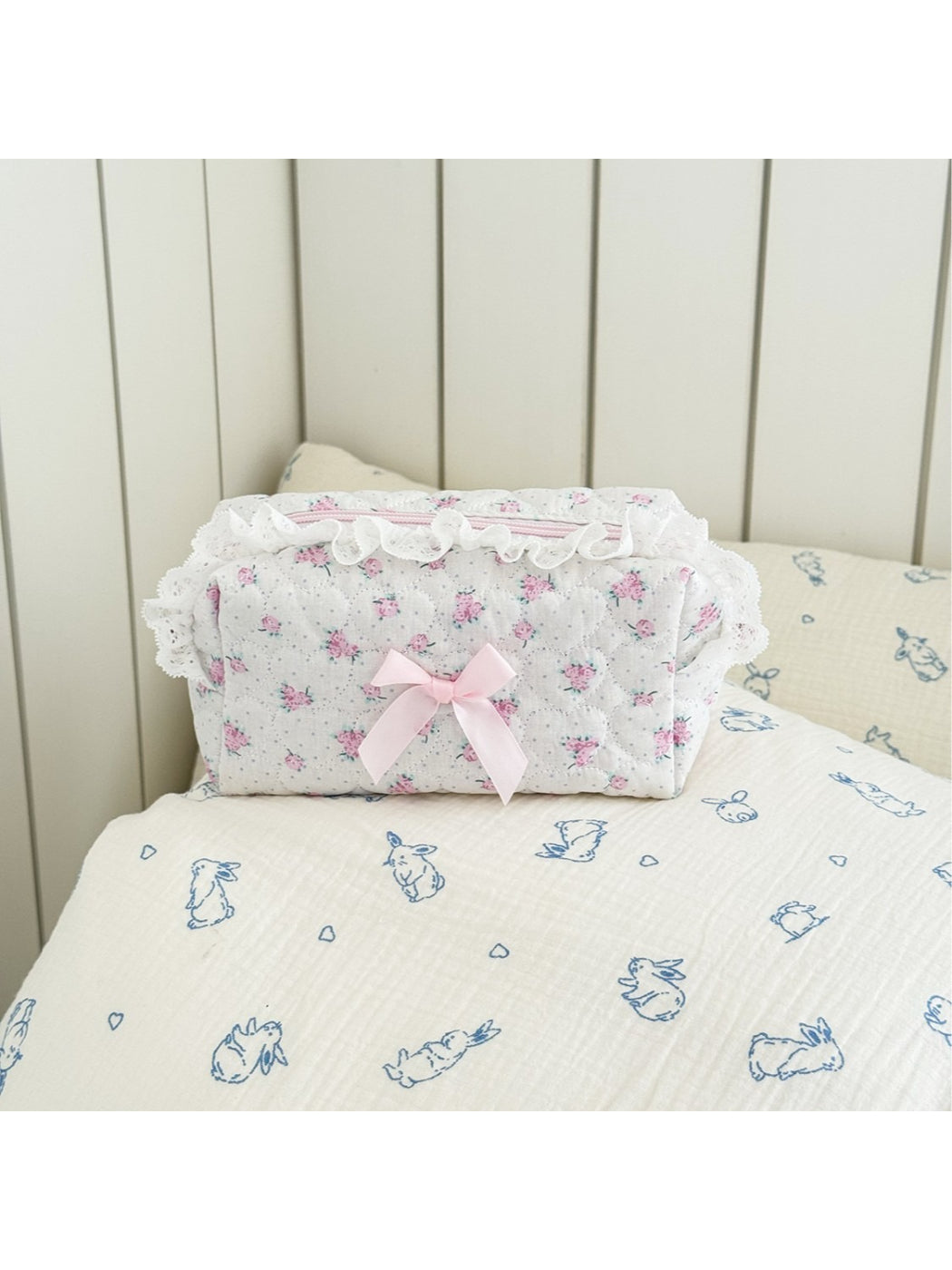 Close-up of pink bow and lace pattern on Cosbai makeup storage bag