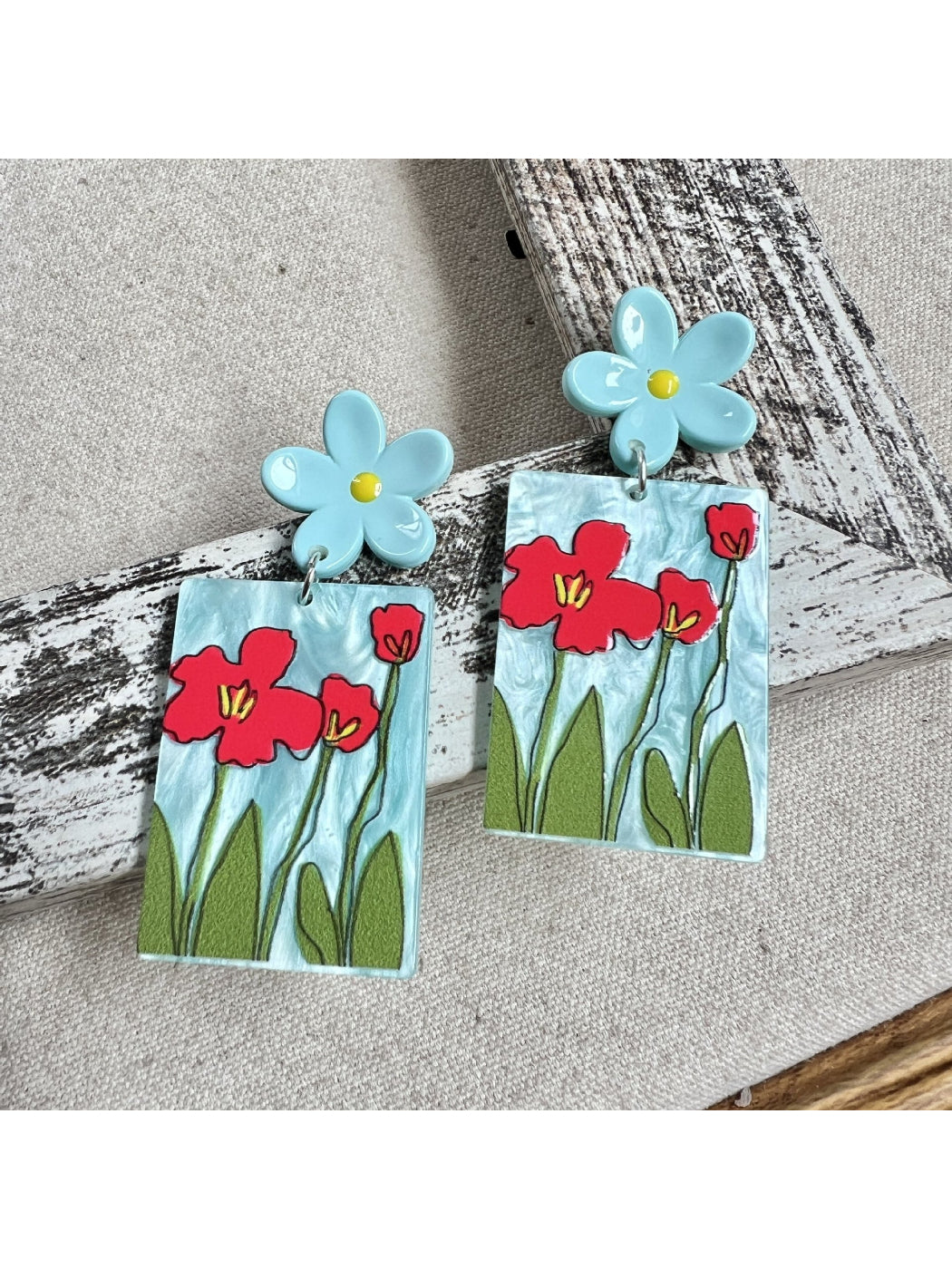Side view of Earwish Painted Flower Drop Earrings showing metal hooks and painted flowers