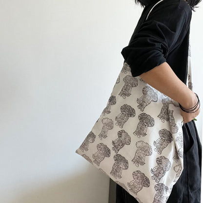 Cosbai tote bag with animal and floral design held by a model