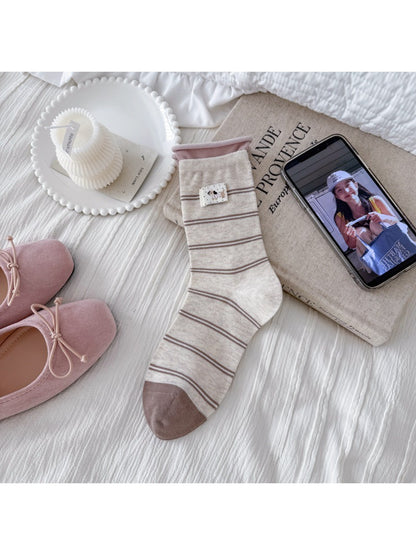 Model wearing Rufia Dog Color Block Mid-Calf Socks with blue and beige color blocks
