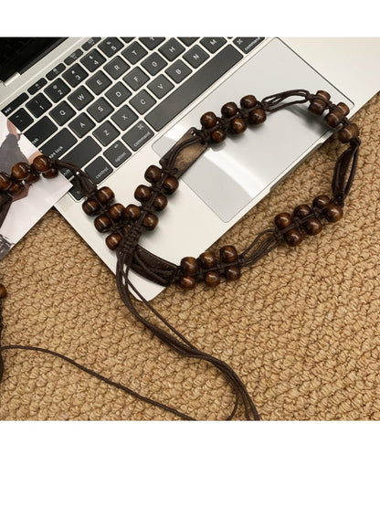 Side view of Beco brown beaded tie waist belt highlighting bead details and texture