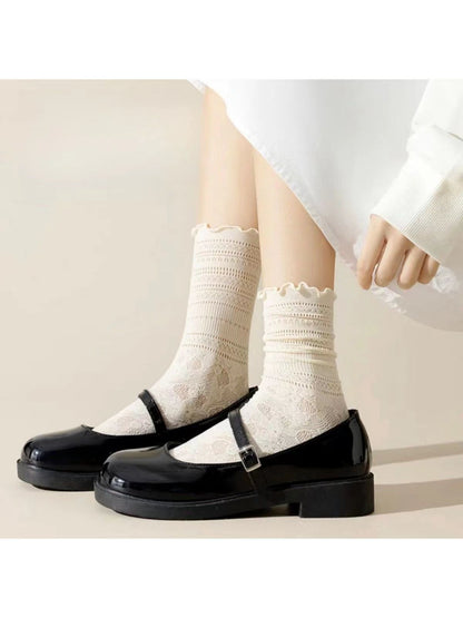 Pair of Rufia Sheer Heart Pattern Crew Socks laid flat showing full heart pattern