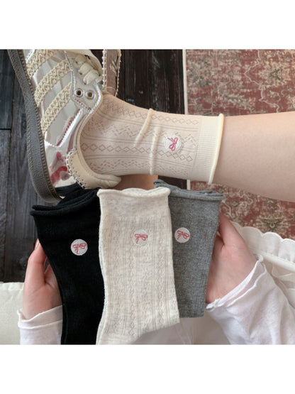 Model wearing Rufia casual bow knit socks with bow detail visible above ankle