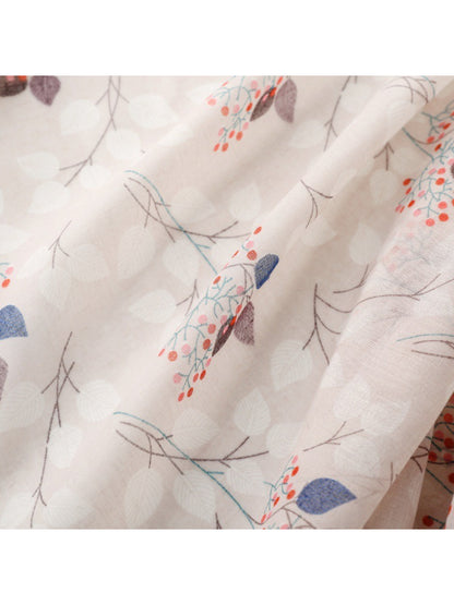 Scarf folded neatly displaying the full botanical print and soft material