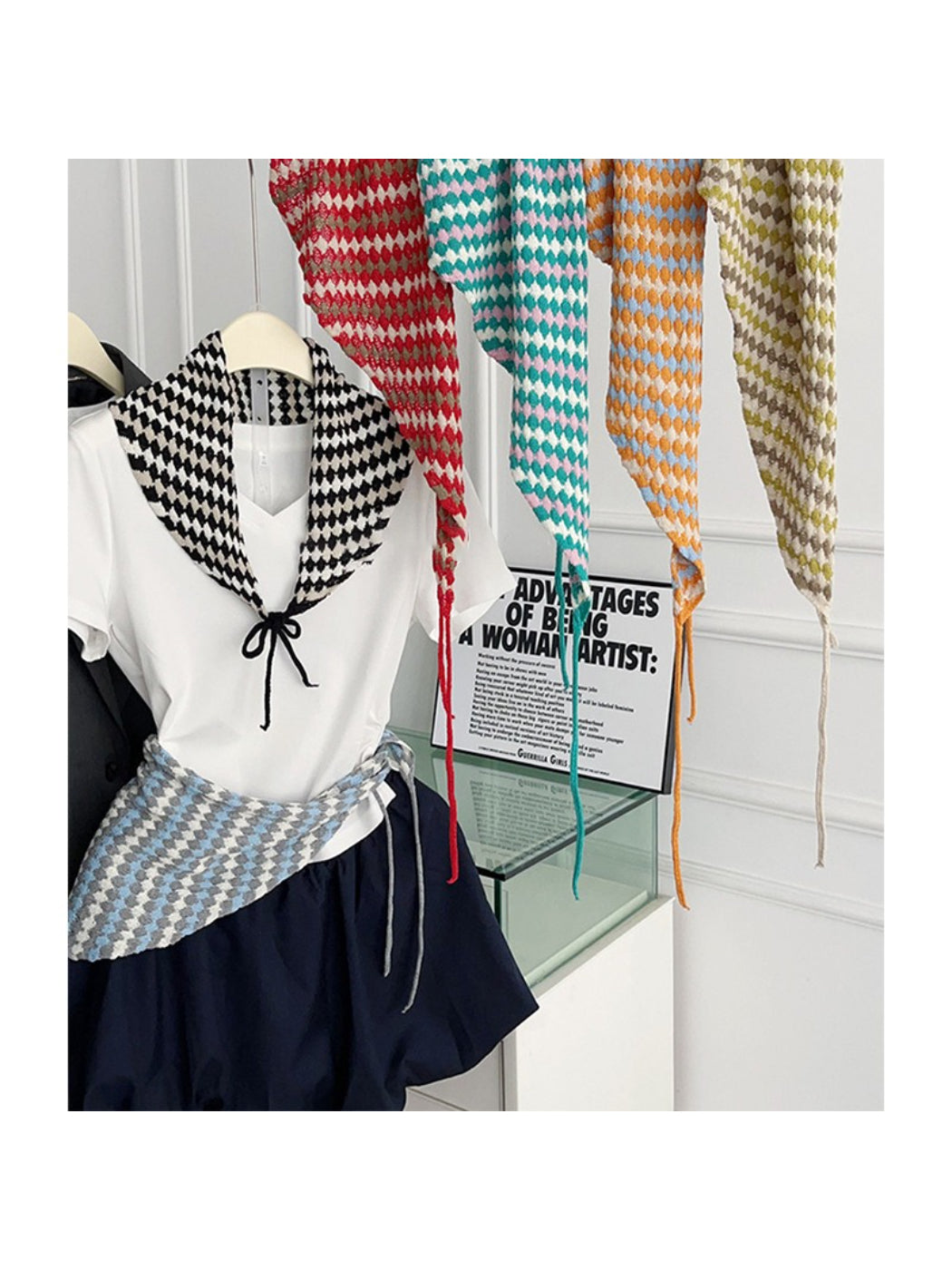 Open knit diamond triangle scarf in cream color displayed flat