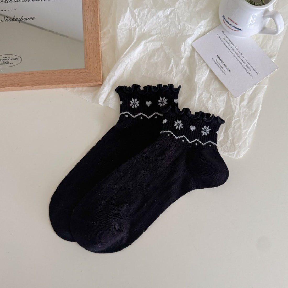 Model wearing Rufia Nordic Heart Frill Crew Socks with frill trim and red heart pattern