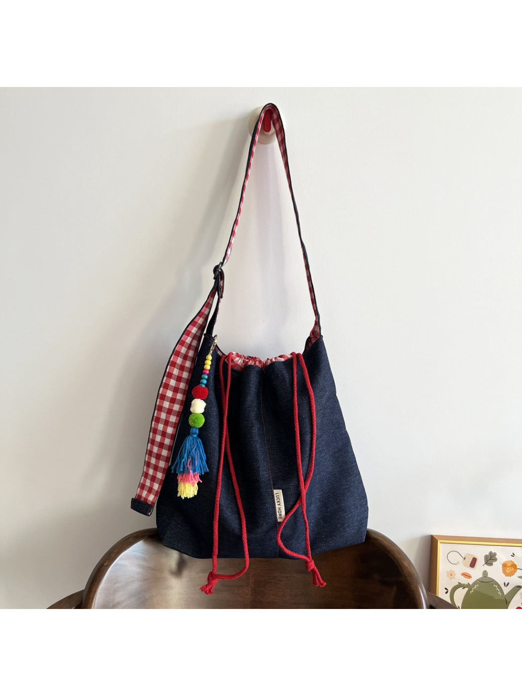 Cosbai gingham trim tassel bucket bag front view with drawstring closure